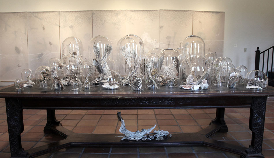 The influence of science is obvious in much of Nguyen's work. A stack of bell jars.