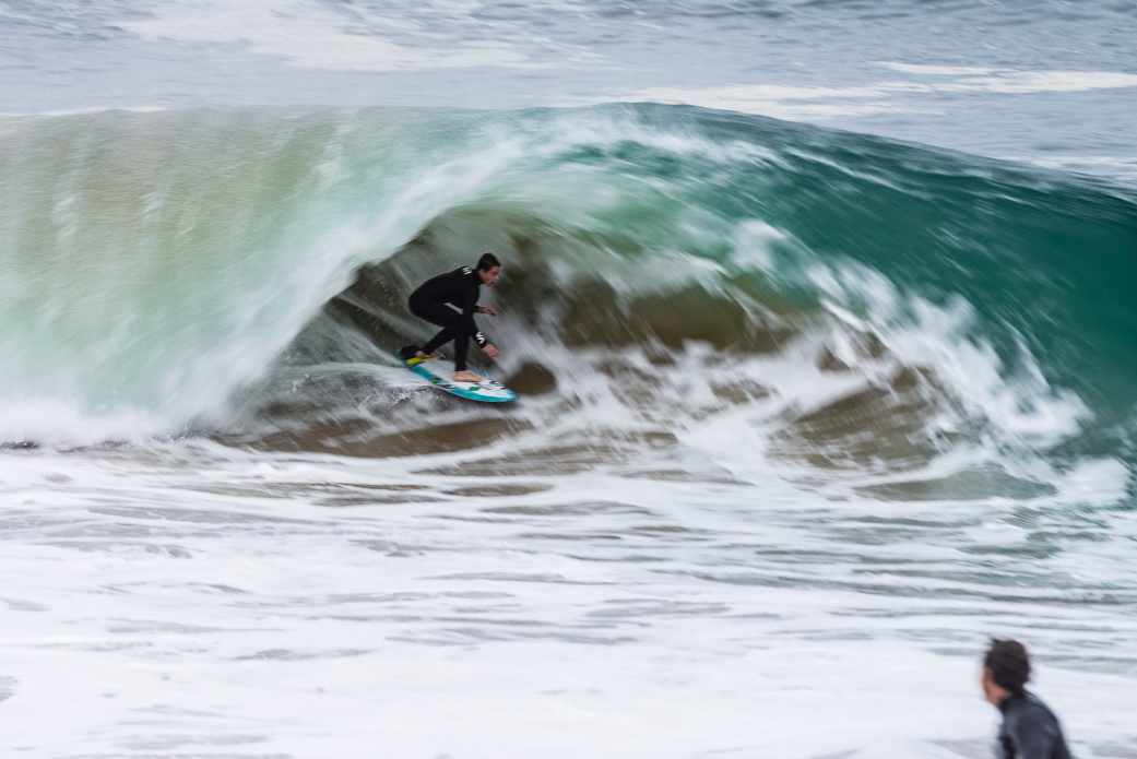 Surfers and bodyboarders risk the waters for big waves after a nearby shark attack at Wedge, Newport Beach, CA.