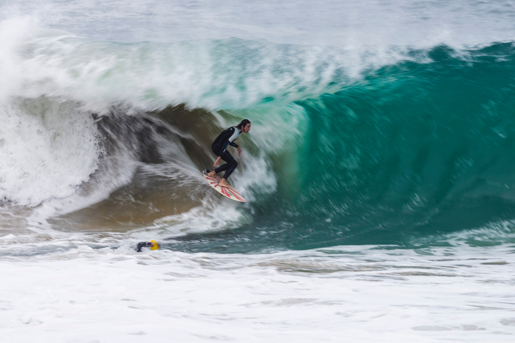 Surfers and bodyboarders risk the waters for big waves after a nearby shark attack at Wedge, Newport Beach, CA.