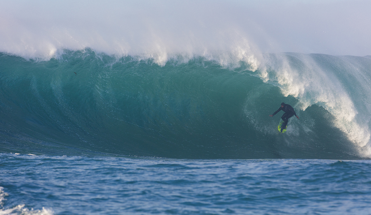 Big wave surfers tow-in at a remote reefbreak near Dunedin, New Zealand.