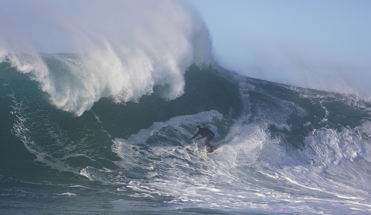 Big wave surfers tow-in at a remote reefbreak near Dunedin, New Zealand.