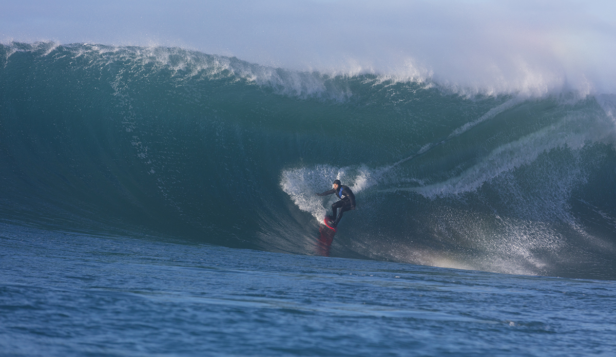 Big wave surfers tow-in at a remote reefbreak near Dunedin, New Zealand.