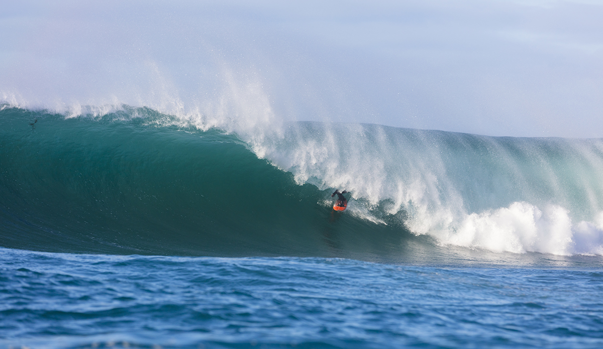 Davy Wooffindin rides a large barrel at a remote reefbreak near Dunedin, New Zealand.