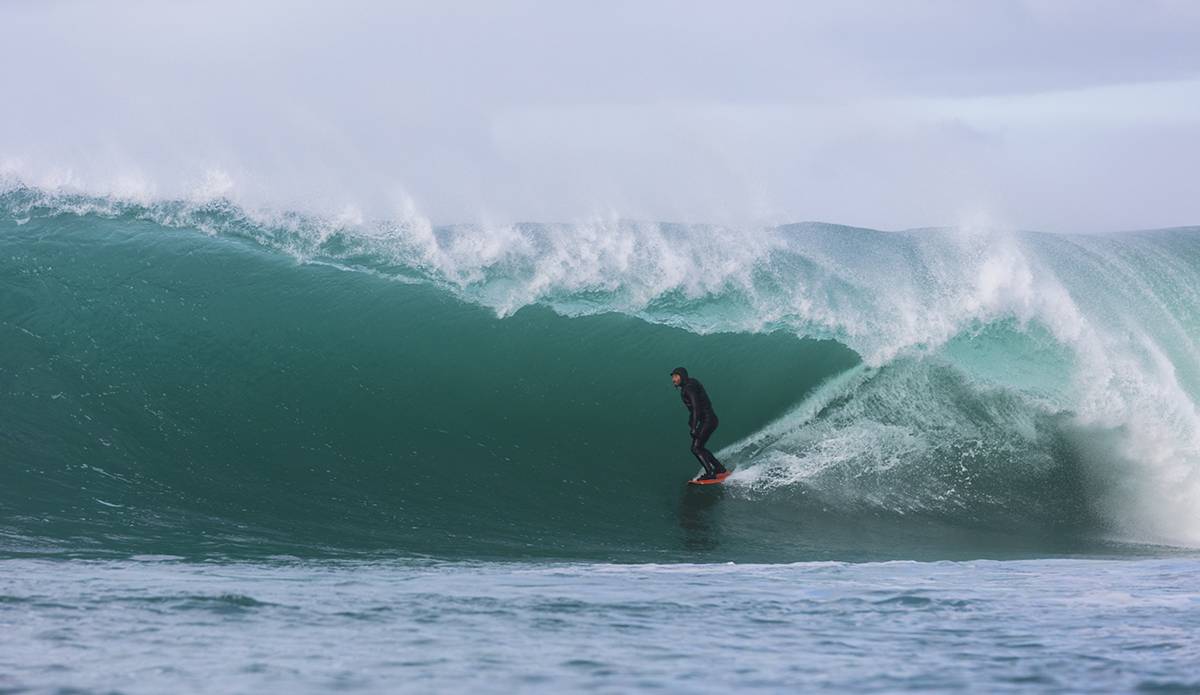Davy Wooffindin rides a large barrel at a remote reefbreak near Dunedin, New Zealand.