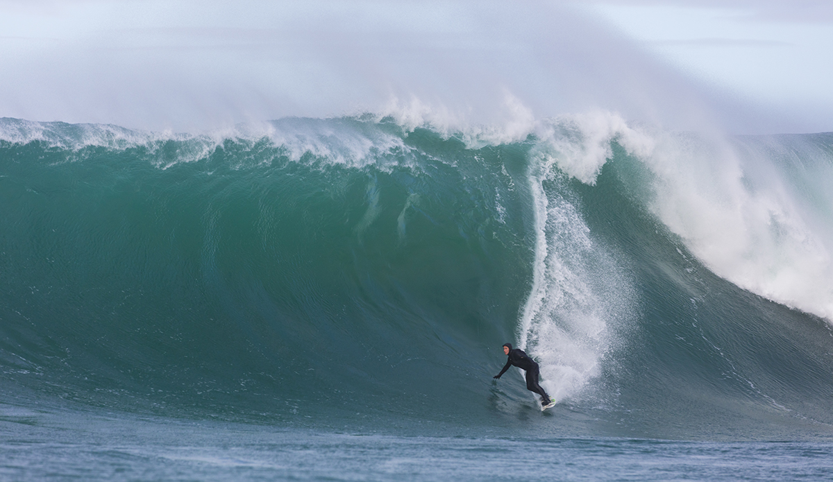 Big wave surfers tow-in at a remote reefbreak near Dunedin, New Zealand.