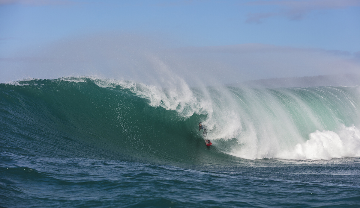 Big wave surfers tow-in at a remote reefbreak near Dunedin, New Zealand.
