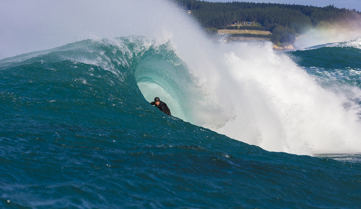 Big wave surfers tow-in at a remote reefbreak near Dunedin, New Zealand.
