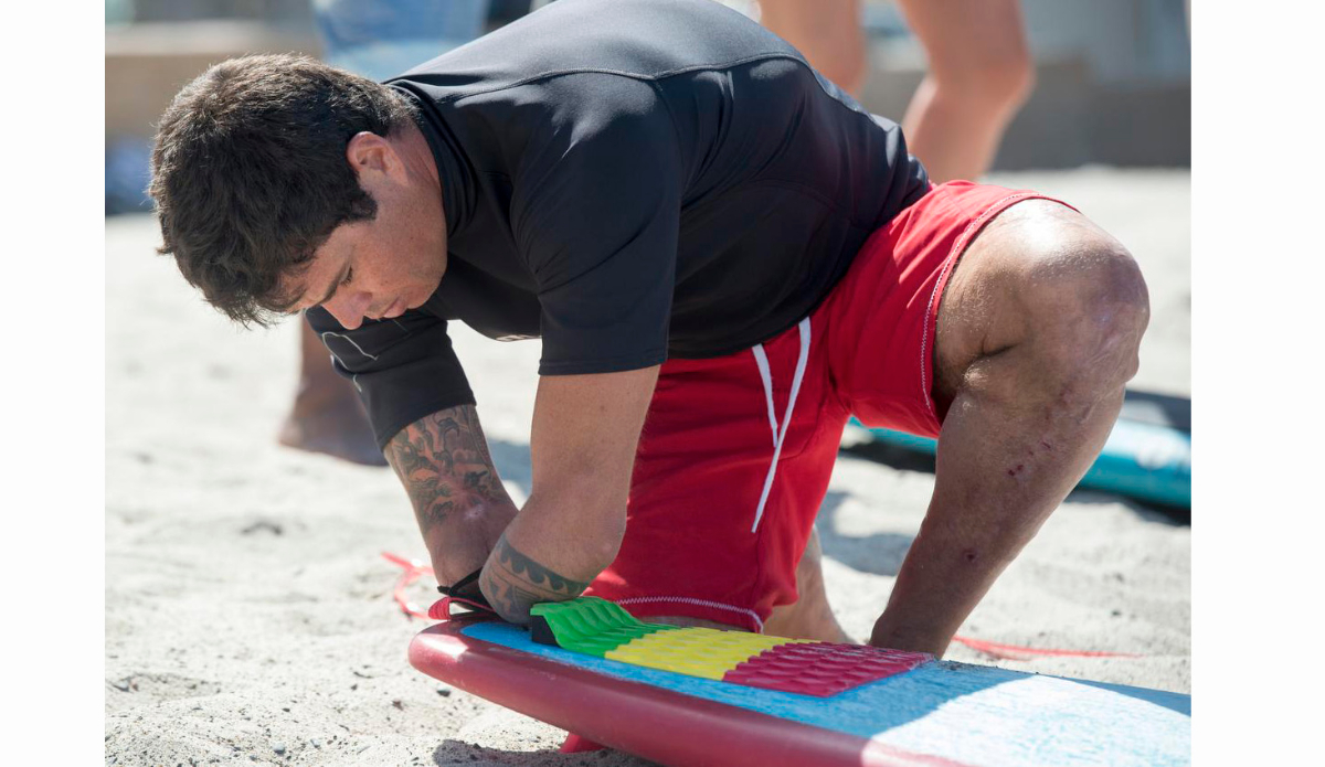 Jonas Letieri is a Brazilian surfer who lost both arms in an electrical accident puts on his leash before taking his board out for a surf in San Clemente.ADDITIONAL INFO:01.0713.sc.DOUBLEAMPUTEESURFER.mg - 07/10/2016  -  MANDATORY CREDIT: MICHAEL GOULDING, ORANGE COUNTY REGISTERSpectators at this weekend\'s San Clemente Ocean Festival can expect to be inspired by Jonas Letieri, a Brazilian surfer who lost both arms in an electrical accident and has found a way to resume surfing as a stand-up paddler using specially crafted paddles he attaches to his arm stumps. He can switch from one arm to the other, as needed. He is considered the Bethany Hamilton of Brazil, and his story is inspiring.We can show how he carries the board, how he attaches the paddle and how he switches from one arm to the other while riding a wave, and how he can throw spray doing cutbacks. We will watch him train in the surf at the San Clemente Pier, where the games will be this weekend. He will compete in SUP surfing and SUP paddle racing.