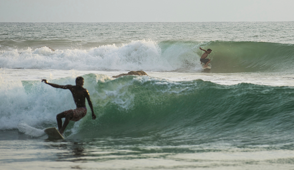 kwepunha-retreat-co-founder-daniel-hopkins-and-mohamed-bangura-of-the-bureh-beach-surf-club-sharing-waves-in-robertsport-liberia