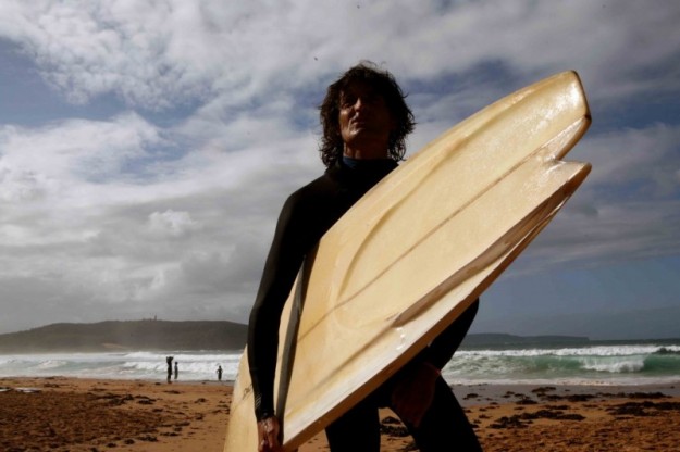 "If you can walk on the beach and read a book instead of sit in a room then do the former before life is totally consumed," says Derek Hynd. Photo: Jamie Brisick Derek Hynd and his finless surfboard
