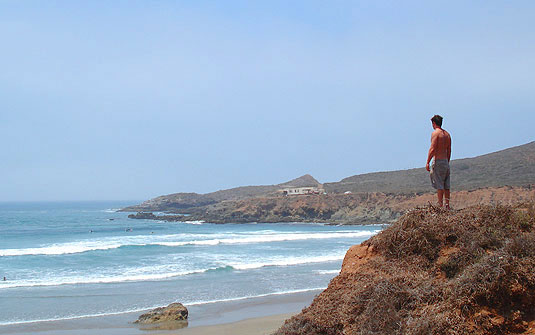 We stood on the bluff watching waves break into a giant bay. The swell looked pretty solid. A surf would cleanse our desert grime, ease our travel funk. But with darkness near, it was too late to paddle out. Camping Baja Surf Trip