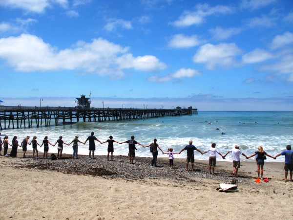 The government must have recognized the intention of movements like Hands Across the Sand and the public's dedication to preserving our coastlines. Photo: Weisberg Hands Across the sand protect our beaches