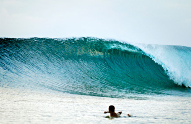 Surfing is about communion. It's about appreciating a breaking wave so much so that one feels moved to hitch a ride. This is surfing in its purest expression. Photo: Getty Perfect Empty Wave Surfer Surfing
