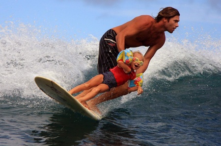 Sion Milosky surfs with his daughter.