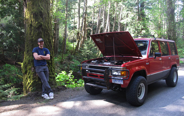 "Ya see...I don't know much about cars, but the problem is in there." Broken Down Car in Woods