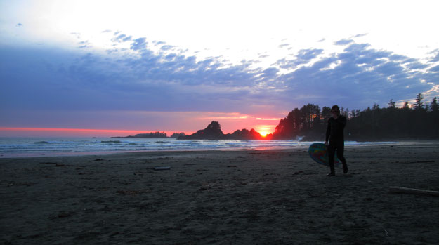 The sun sets around 9:15 PM in Vancouver Island in May. Science rules. Surfer Walking Sunset Cox Bay Tofino Vancouver Island