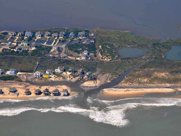 An aerial view of my neighborhood. Note: that ribbon of water bisecting the island should not be there. Photo: Associated Press/StarNewsOnline.com Aerial View Damage Rodanthe North Carolina Irene