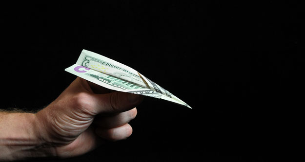 "I couldn’t fathom leaving my board behind. I paid the ridiculous amount with my credit card adding it to my escalating debt." Photo: Shutterstock