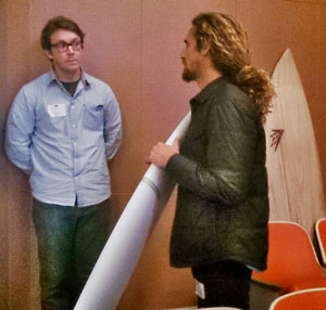 Falken shows a BIOM blank to Machado. A Timbertek rests on the wall.