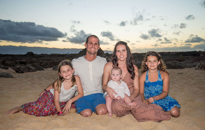 The Hobgood family, smiling and sandy.