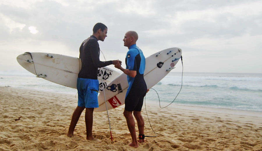 Blind surfer Derek Rabelo gets a few tips from the king, Kelly Slater.