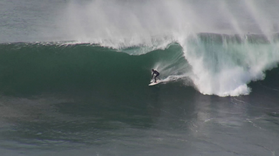 Alex Gray surfs big waves.