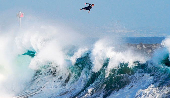 Bobby Okvist airing it out over a triple-overhead wave at The Wedge.