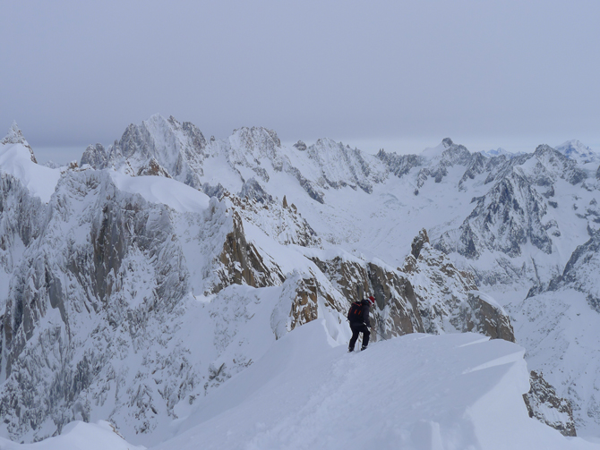 Powder is awe-inspiring but can present significant avalanche danger. Here a skier cautiously descends a corniced ridgeline on the first day of the season in the Valle Blanche (Chamonix, France). Photo: William Van Meegdenburg