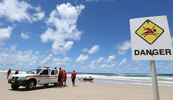 Lifeguards  gather on the beach after the fatal attack and making sure no one enters the waters. Photograph : Jason O'Brien