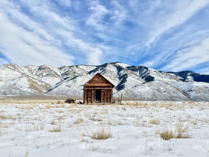 Shot by Cole R. in Star Valley Ranch, WY; establishing a central focal point can have dramatic impact. Here, wispy clouds lead the eye to the hut and create a stronger sense of focus. App Used: Camera