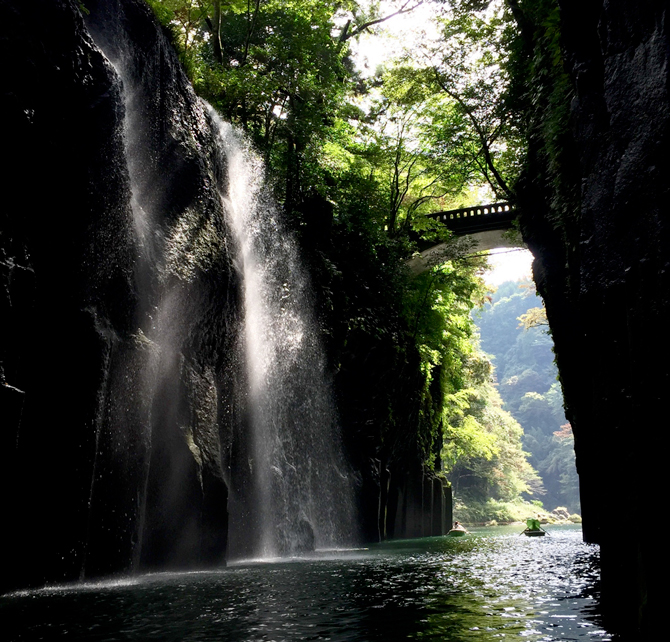 Shot by Gayle T. in Takachiho Gorge, Japan; capturing smaller elements in a scene, like the boat and bridge here, creates a sense of scale and helps larger elements like the waterfall feel more dramatic. App Used: Camera