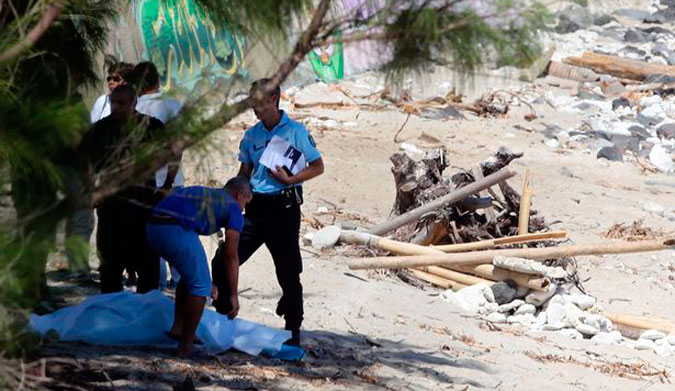 Police stand over the body of Elio Canestri shortly after the attack.