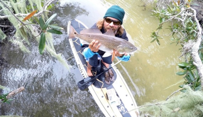 A man who does it all. Tupat with his catch.