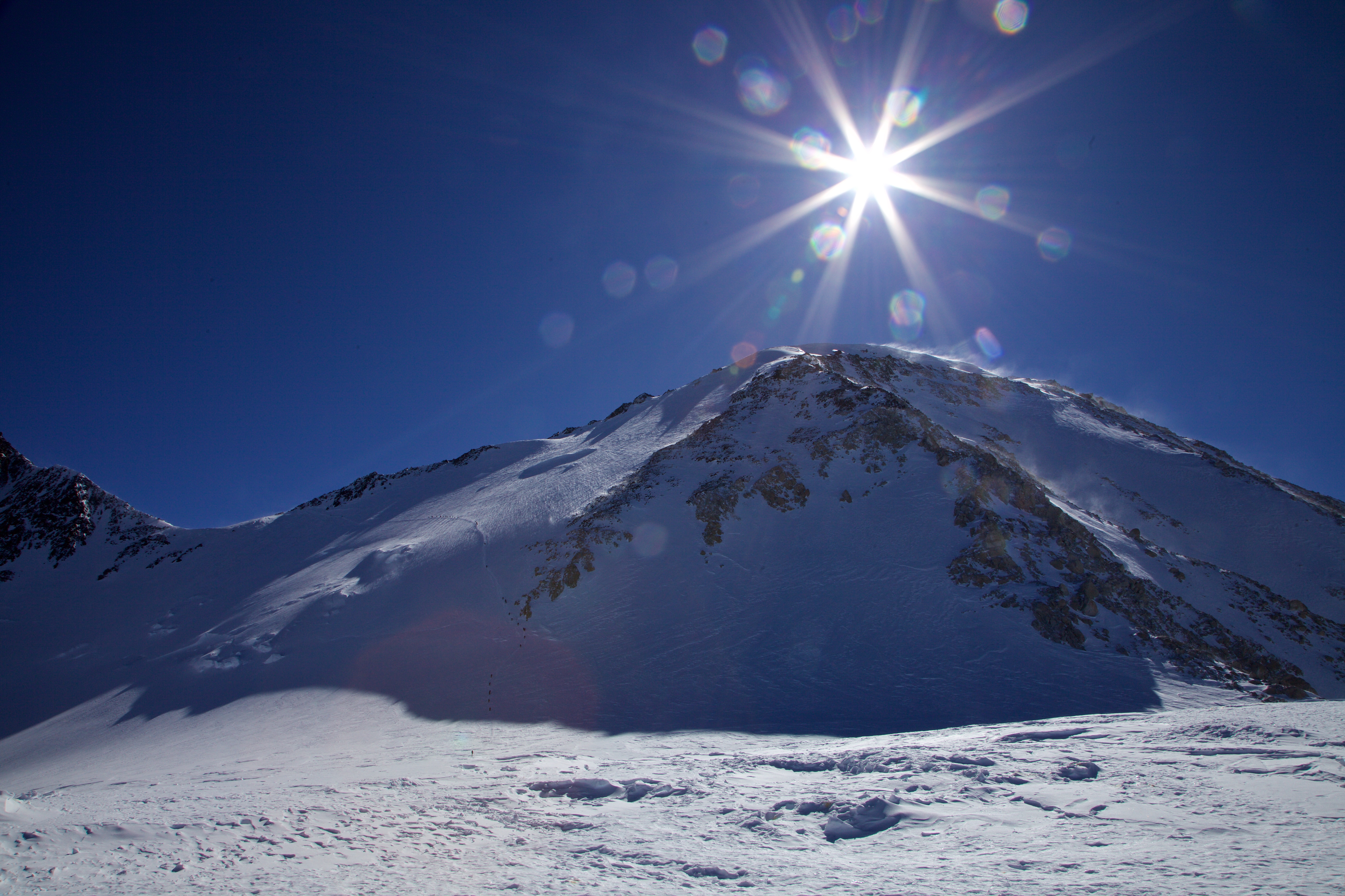 Dave captured this beautiful view of the upper mountain from 17k camp a couple days after I had left the mountain. If you zoom in, you can pick out a string of climbers on the “Autobahn”, the traverse stretching across the large left-facing snow slope in the photo. Photo credit: David Leonard
