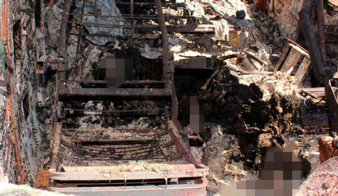 The torched remains of the van and the bodies inside.