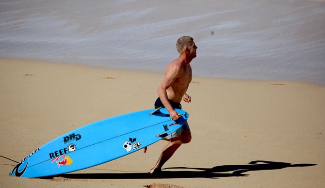Mick Fanning drops his board to run to Evan Geislman's rescue. Photo: Matt Hoffman/Gnarbox