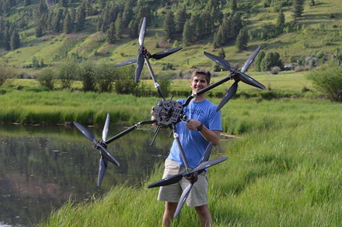 CTO Robert Blank with a drone designed for larger payloads.]