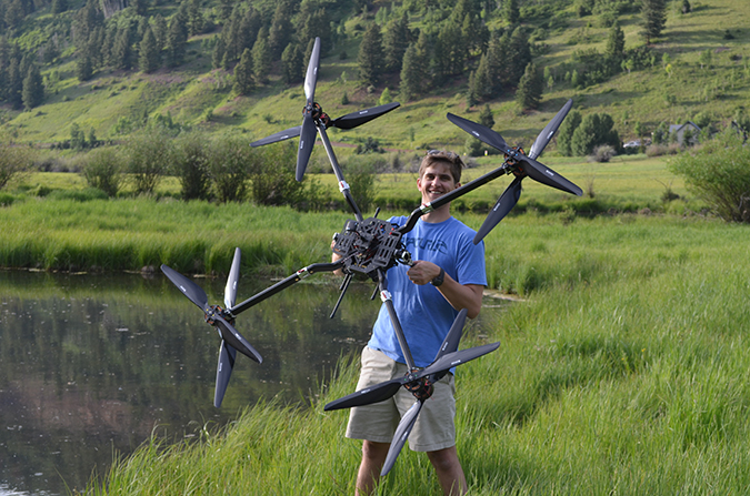 CTO Robert Blank with a drone designed for larger payloads.]