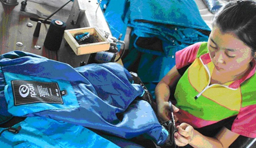 Workers cutting fabric for Rip Curl jackets in a factory about 100 kilometres south of Pyongyang in North Korea.