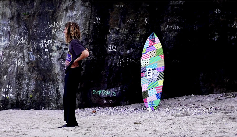 An artist on a surfboard painted by an artist.