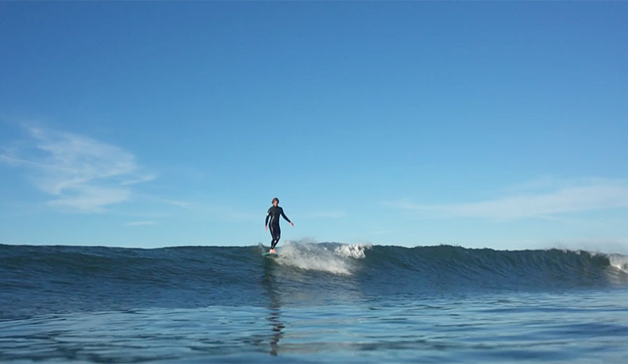 Reilly Stone rides a longboard.