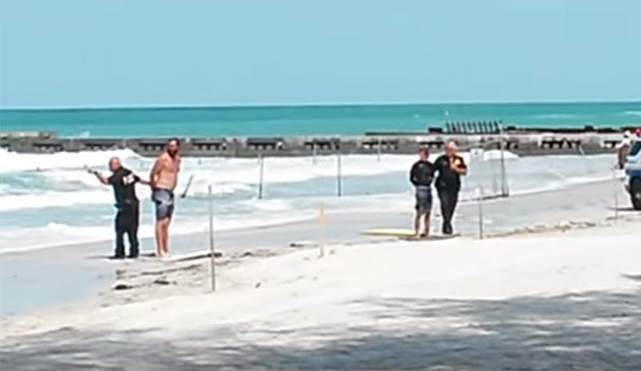 Three surfers detained for surfing near a submerged hazard.