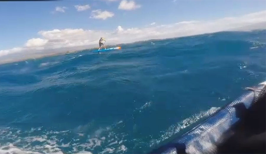 Connor Baxter was knocked onto his back by the tiger shark, but managed to stay on his board.