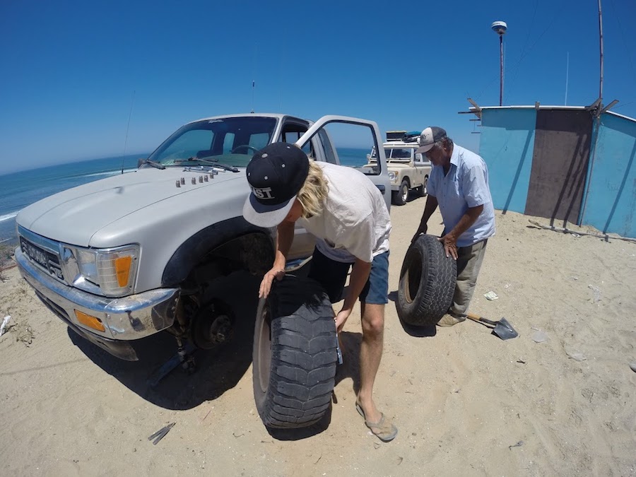 Helping a broken down driver change his tire in Scorpion Bay. Photo: Wyatt Fowler
