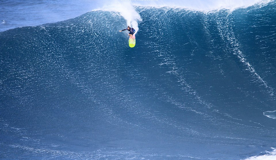 Paige Alms paddles into the wind making this technical airdrop at Jaws. Photo: Aaron Lynton | World Surf League