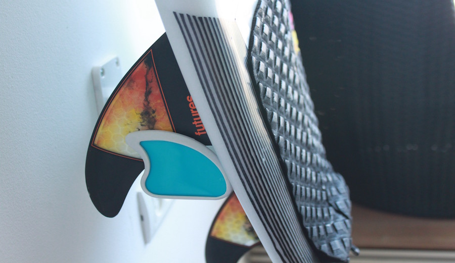 Air surf rack supports boards against wall