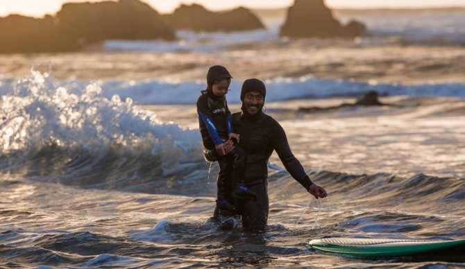 Ramón teaching his son, Inti, to surf at his beloved surf spot, Punta De Lobos. Chile. Photo: Jeff Johnson