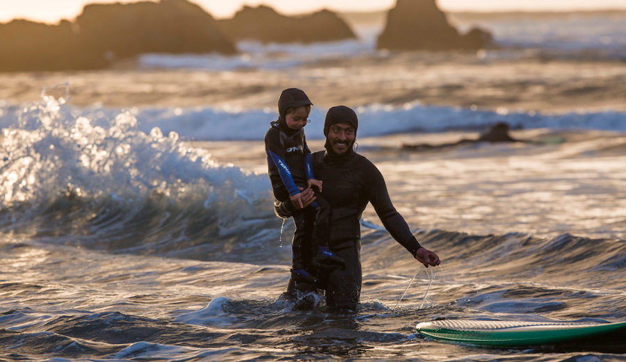 Ramón teaching his son, Inti, to surf at his beloved surf spot, Punta De Lobos. Chile. Photo: Jeff Johnson