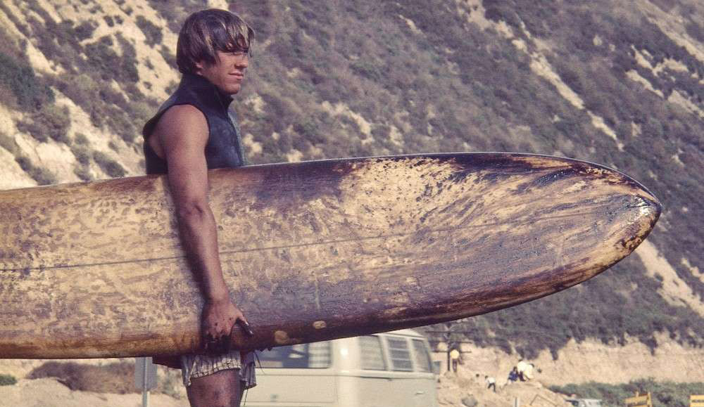 A Santa Barbara surfer covered in oil following the 1969 spill. Courtesy of Bud Bottoms