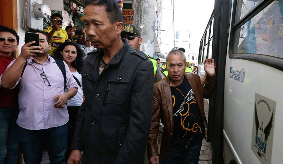 Crew members of the Chinese-flagged ship confiscated by the Ecuadorean Navy arrive in court in San Cristobal, Galapagos Islands on August 25, 2017. Photo: AFP